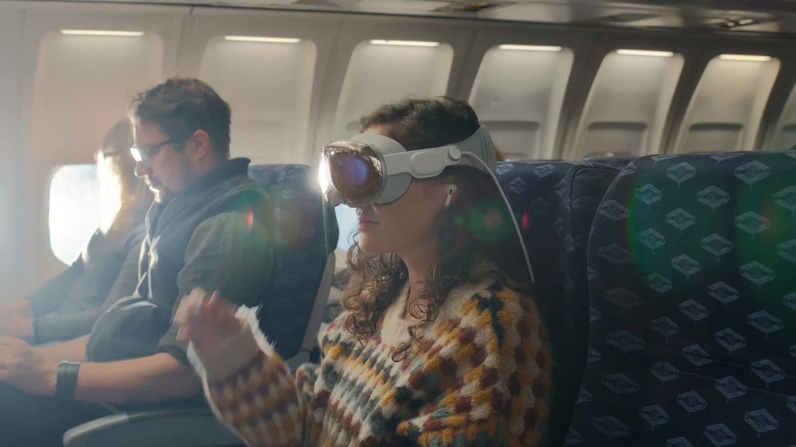 Woman in plane wearing apple vision pro